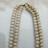 A fashionable and trendy stainless steel necklace with multiple sets of off-white glass beads Specification image